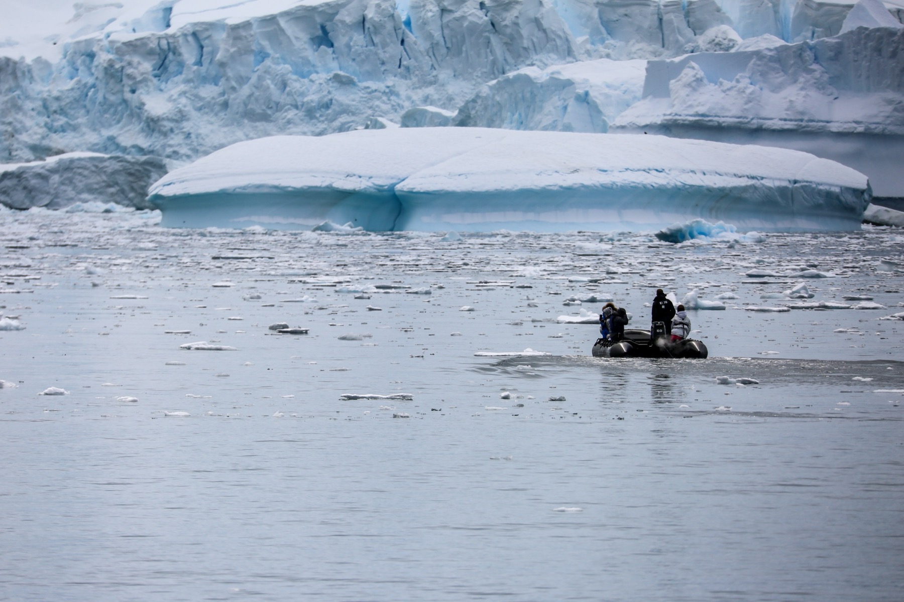 Expedition tender beneath a glacier